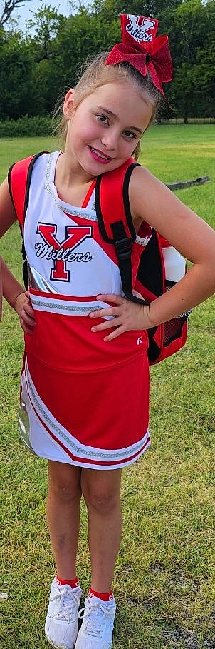 Bellah is registered to the contest to win money with this photo: active_tank, chest, clothing, grass, jersey, joint, joy, person, personal_protective_equipment, player, red, shorts, sleeve, sleeveless_shirt, sports_jersey, sports_uniform, sportswear, t_shirt, thigh, uniform