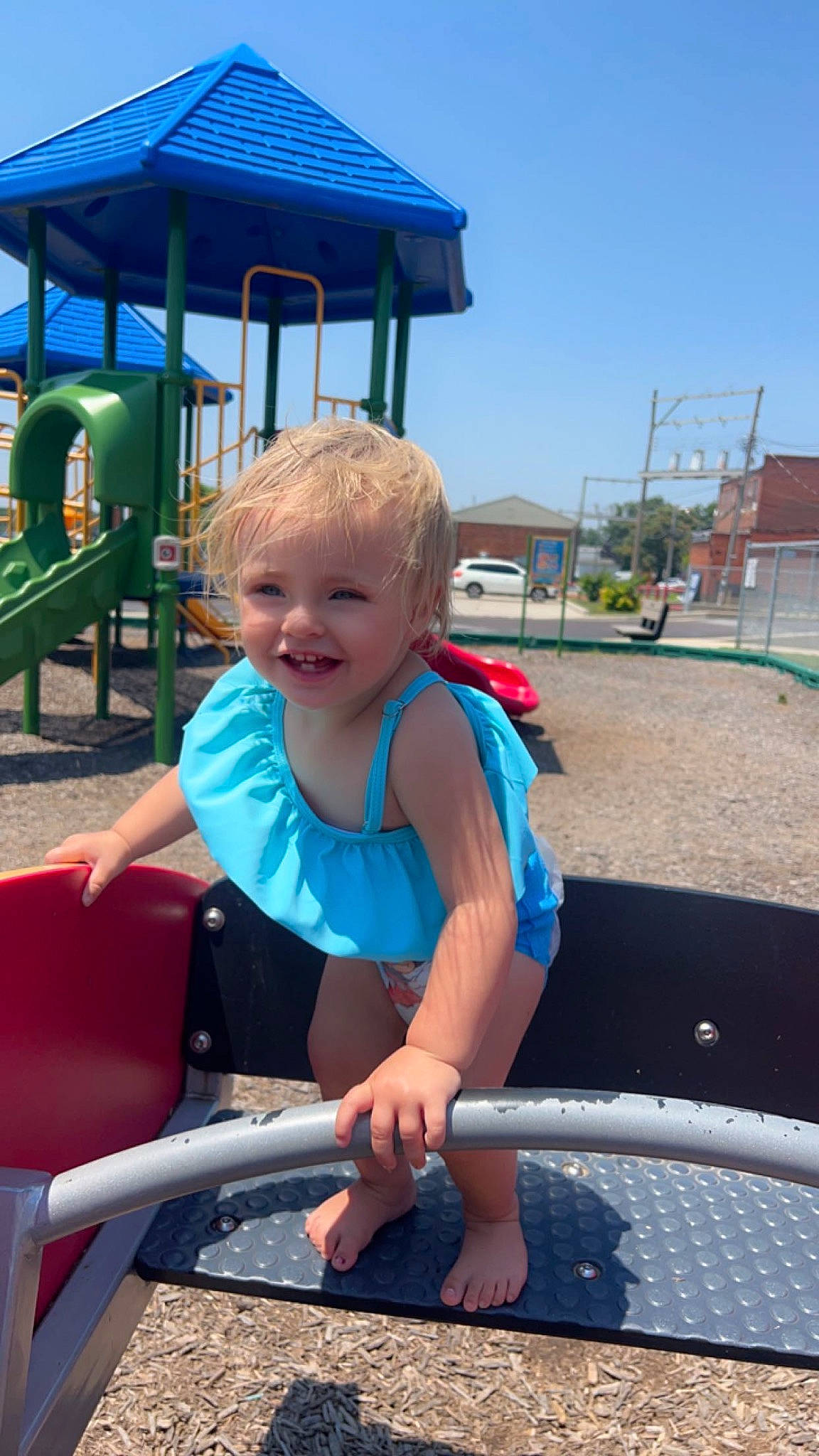 Lydia is registered to the contest to win money with this photo: blue, child, city, electric_blue, fun, happy, joy, leisure, outdoor_furniture, outdoor_play_equipment, person, play, playground, product, recreation, shade, sky, smile, snapshot, summer