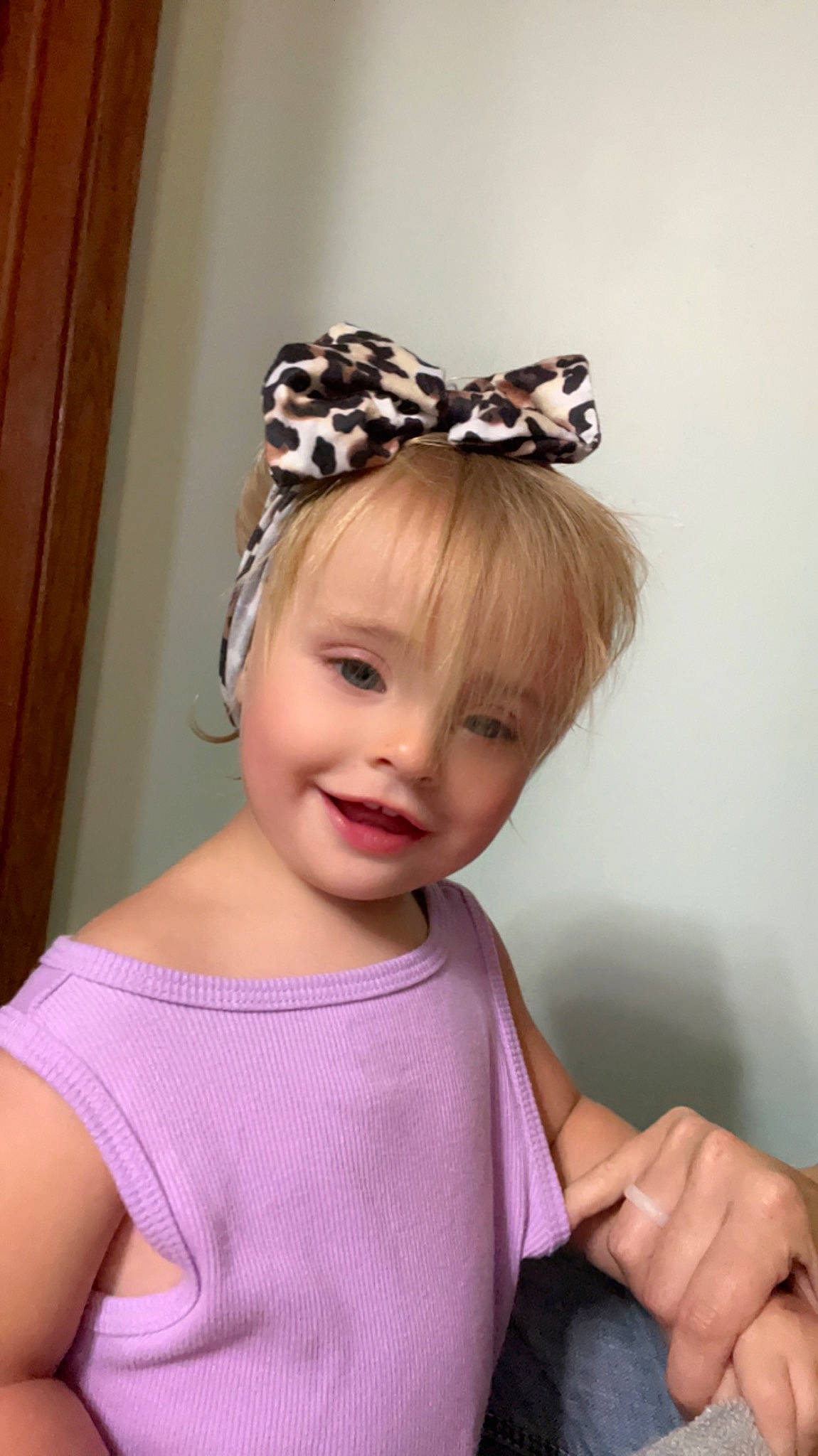 Lydia is registered to the contest to win money with this photo: baby_toddler_clothing, bridal_accessory, clothing, costume_hat, dress, ear, eyebrow, eyelash, gesture, happy, head, headband, headgear, headpiece, helmet, joy, person, pink, sleeve, smile