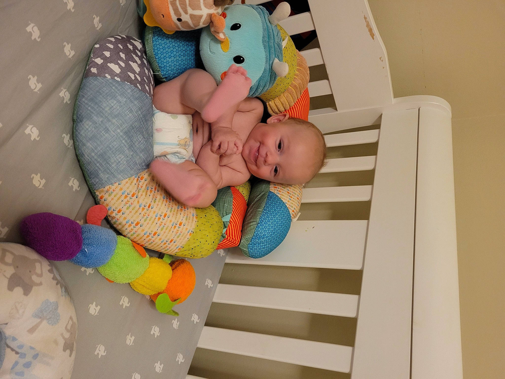 Abraham is registered to the contest to win money with this photo: arm, baby, baby_products, baby_safety, baby_sleeping, baby_toddler_clothing, baby_toys, bedding, bedtime, child, comfort, joy, linens, pattern, person, product, room, sitting, sock, textile