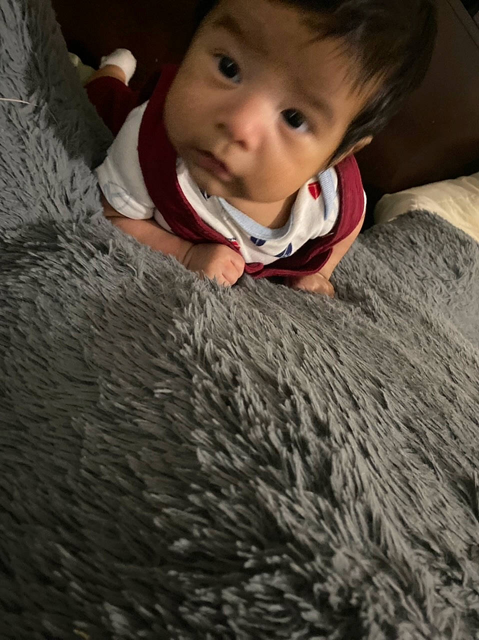 Gerardo is registered to the contest to win money with this photo: carpet, child, comfort, cool, eye, eyebrow, facial_expression, flash_photography, flooring, fun, grass, hair, happy, linens, nose, outerwear, person, sitting, smile, toddler