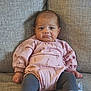 Emelia is registered to the contest to win money with this photo: baby, infant, child, couch, sofa, pink_outfit, leggings, white_booties, ribbons, cute, pout, indoor, portrait, seated, furniture, soft_texture, young_child, expression, cozy, home