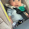 Carter is registered to the contest to win money with this photo: baby, car_seat, pacifier, plush_toy, infant, straps, blue_clothing, cute, child, seatbelt, closeup, indoors, safety, smiling, face, head, person, young_child, comfort, resting