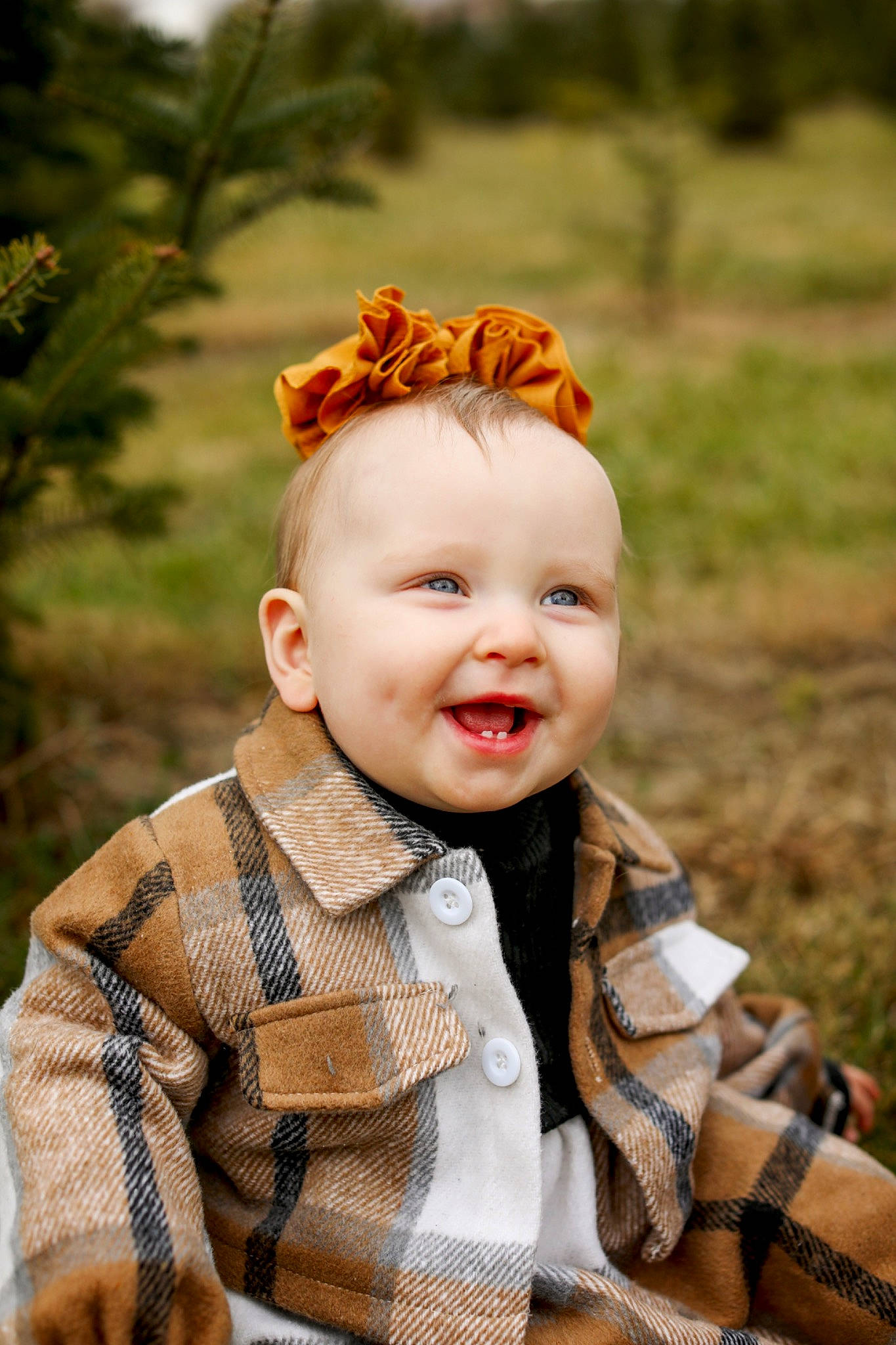 Charlotte is registered to the contest to win money with this photo: baby, baby_toddler_clothing, blond, eye, flash_photography, fun, grass, happy, headgear, outerwear, pattern, people_in_nature, person, plaid, plant, skin, sleeve, smile, toddler, tree