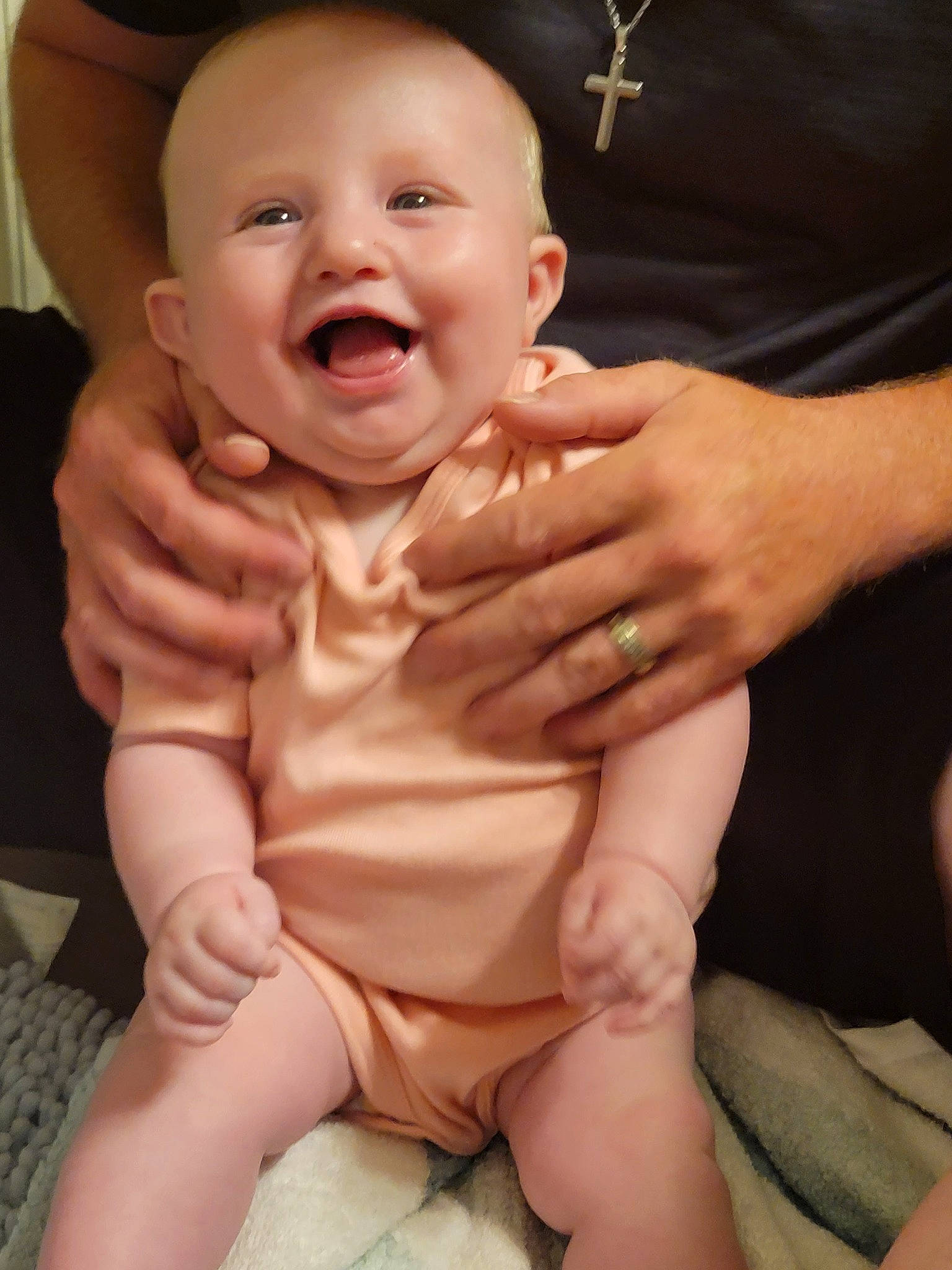 Emmie is registered to the contest to win money with this photo: baby, baby_toddler_clothing, cheek, comfort, eye, eyebrow, face, finger, gesture, hand, happy, head, lip, mouth, nose, person, skin, sleeve, smile, stomach