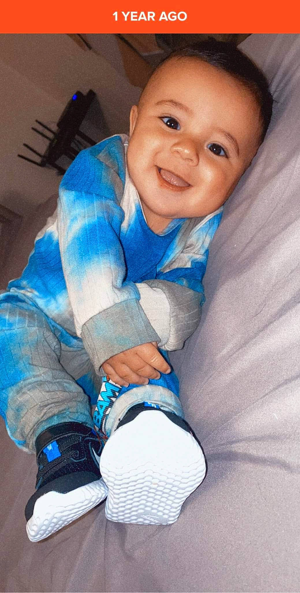 Roman is registered to the contest to win money with this photo: arm, azure, baby, baby_toddler_clothing, child, comfort, electric_blue, finger, flash_photography, fun, gesture, happy, human_leg, joy, person, skin, sleeve, smile, thumb, toddler