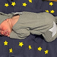 Malakai is registered to the contest to win money with this photo: newborn, baby, sleeping, onesie, hat, moon, stars, blanket, blue, yellow, cozy, infant, cute, portrait, resting, soft, child, toddler, face, peaceful