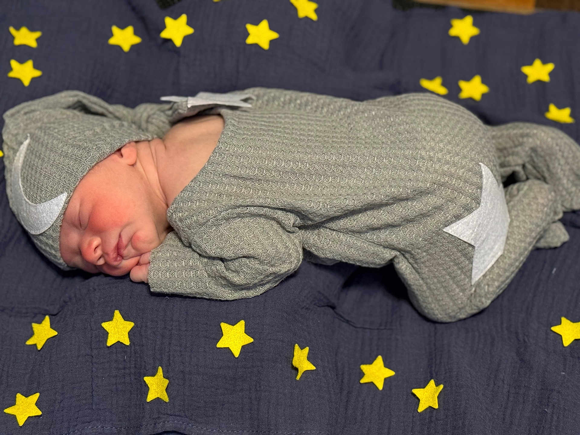 Malakai is registered to the contest to win money with this photo: newborn, baby, sleeping, onesie, hat, moon, stars, blanket, blue, yellow, cozy, infant, cute, portrait, resting, soft, child, toddler, face, peaceful