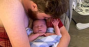 River joined the competition — help win amazing prizes! baby, man, blanket, couch, indoor, sleeping, holding, affection, family, parent, child, love, skin, head, arm, floor, furniture, beard, chain, comfort