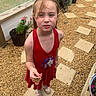 Venus is registered to the contest to win money with this photo: child, girl, red_dress, unicorn, butterfly, garden, gravel, stepping_stone, plants, potted_plants, outdoor, curious, expression, hair, sneakers, nature, summer, portrait, standing, flower