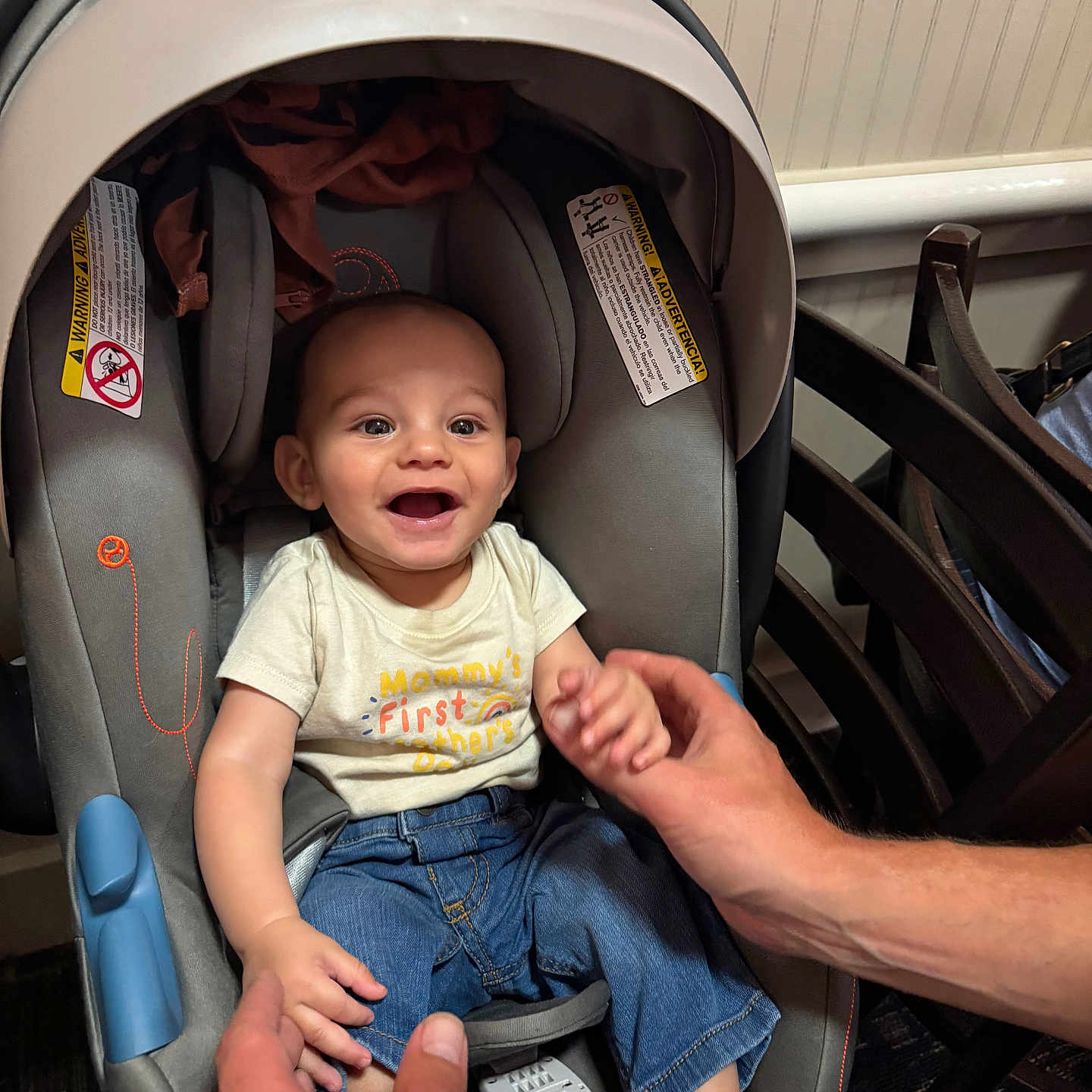 Liam is registered to the contest to win money with this photo: adult, baby, bodypart, car, clothing, face, finger, hand, head, jeans, male, man, pants, person, photography, portrait, stroller, t_shirt, transportation, vehicle
