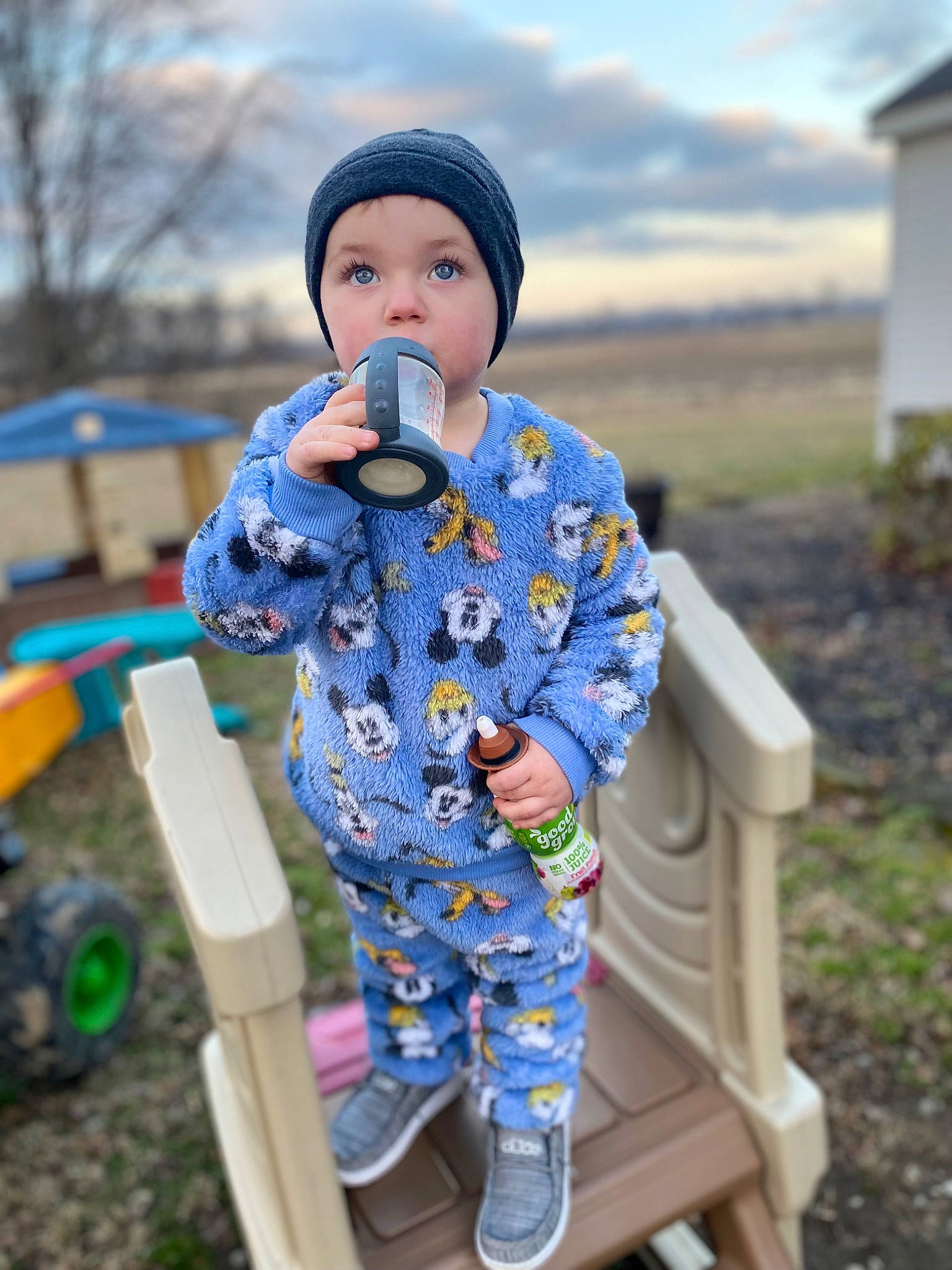 Brantley is registered to the contest to win money with this photo: baby, cap, child, cloud, electric_blue, fun, grass, happy, headwear, jacket, leisure, pattern, person, plant, sitting, sky, sleeve, standing, toddler, toy