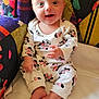 baby, blanket, chair, child, clothing, colorful, cute, expression, face, footwear, hand, happy, indoor, infant, mickey_mouse, minnie_mouse, onesie, patterned, sitting, soft