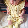 Athena-Rose is registered to the contest to win money with this photo: baby, blue_eyes, buttoned_outfit, casual, child, clothing, colorful_background, curious, cushions, cute, expression, indoor, infant, portrait, quilt, sitting, small_hands, soft_lighting, yellow_outfit, yellow_socks