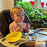 Ozias joined the competition — help win amazing prizes! toddler, child, high_chair, food, spoon, eating, indoor, plants, window, red_glasses, face, messy, bottle, yellow_bowl, blanket, cozy, person, baby, feeding, home
