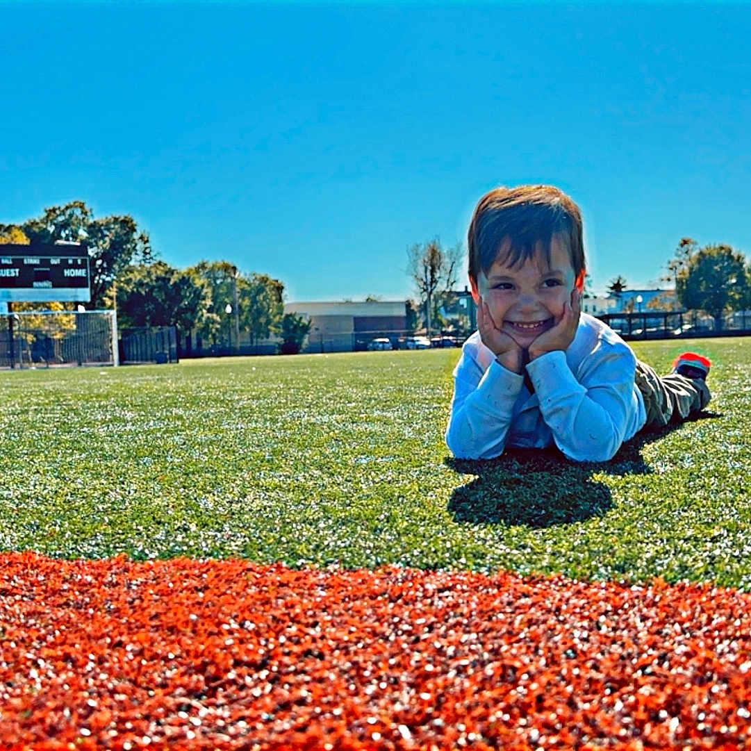 Maxwell joined the competition — help win amazing prizes! baseball, baseballglove, boy, child, clothing, coat, face, field, grass, head, jacket, male, nature, outdoors, park, person, photography, plant, portrait, sitting