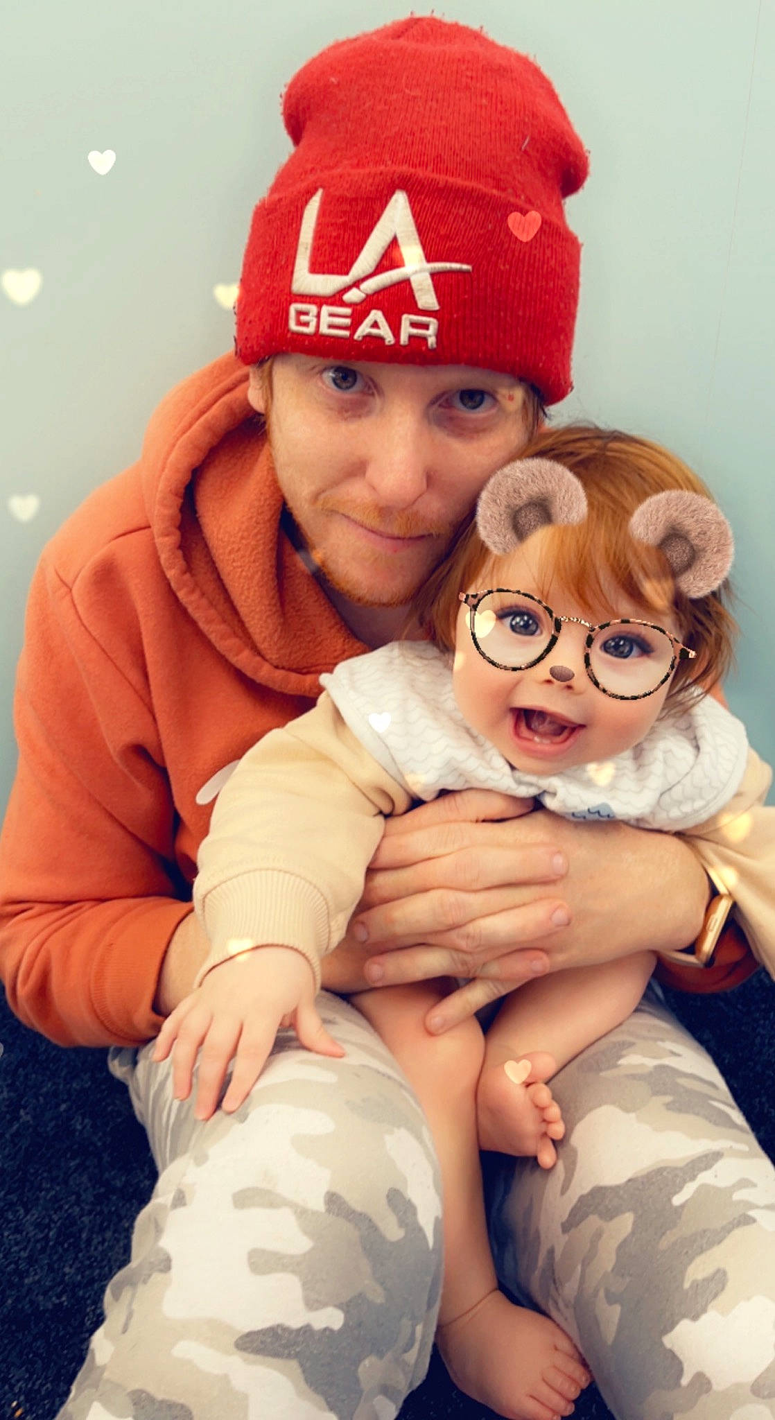 Mayah is registered to the contest to win money with this photo: baby, baseball_cap, beauty, cap, child, comfort, event, facial_expression, fun, gesture, happy, hat, headgear, headwear, interaction, lap, person, sitting, skin, smile