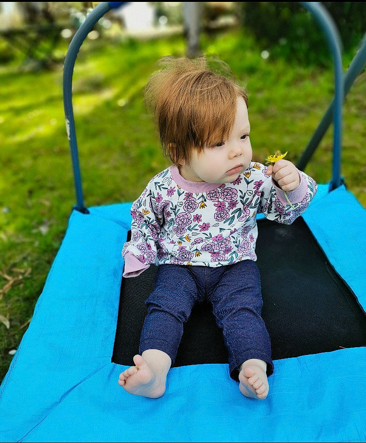 Mayah is registered to the contest to win money with this photo: baby, baby_toddler_clothing, child, city, electric_blue, fun, grass, green, happy, leisure, outdoor_play_equipment, people_in_nature, person, photograph, play, playground, recreation, sitting, sleeve, t_shirt
