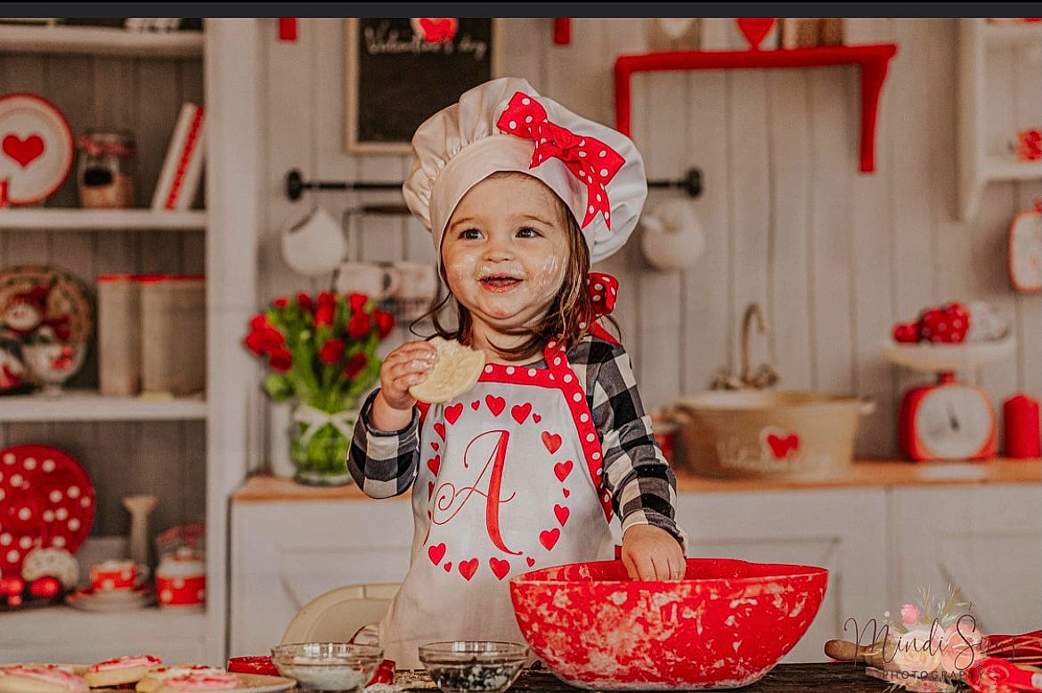 Addie is registered to the contest to win money with this photo: child, christmas, christmas_eve, cooking, event, happy, hat, headwear, holiday, joy, orange, pattern, person, pink, plate, recipe, red, smile, snapshot, sweetness