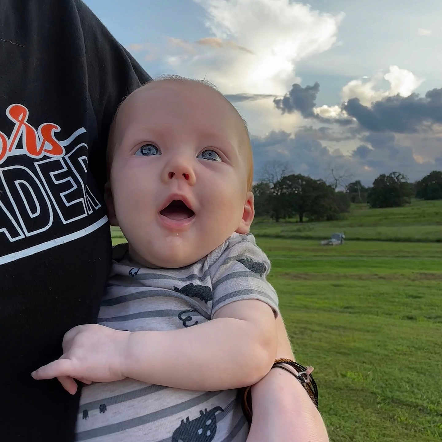Beckett is registered to the contest to win money with this photo: baby, clothing, cloud, face, grass, happy, head, lawn, nature, outdoors, park, people, person, photography, plant, portrait, shirt, sky, t_shirt, tree