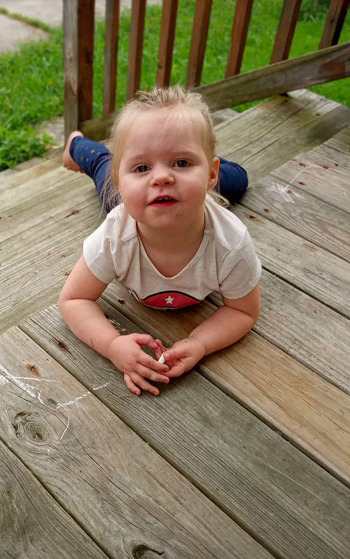 Ella is registered to the contest to win money with this photo: baby, baby_toddler_clothing, cheek, child, deck, eye, face, floor, flooring, grass, happy, hardwood, head, nose, person, plank, skin, thumb, toddler, wood