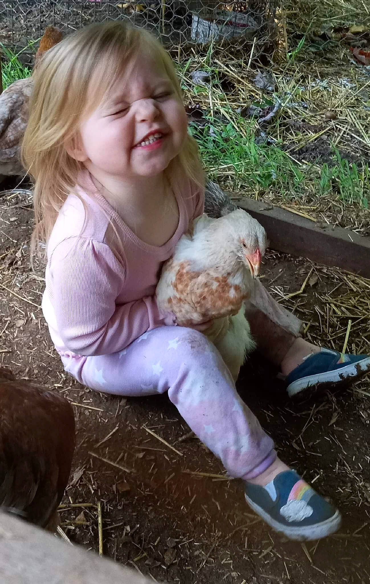 Ella joined the competition — help win amazing prizes! baby_toddler_clothing, blond, boot, child, eye, fawn, finger, fun, grass, grass_family, happy, human_leg, people_in_nature, person, plant, shoe, sitting, smile, sneakers, soil