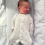 Leo is registered to the contest to win money with this photo: baby, newborn, sleeping, onesie, white, blue_dots, blanket, soft, cozy, infant, peaceful, cute, portrait, bed, child, sleep, face, head, clothing, resting