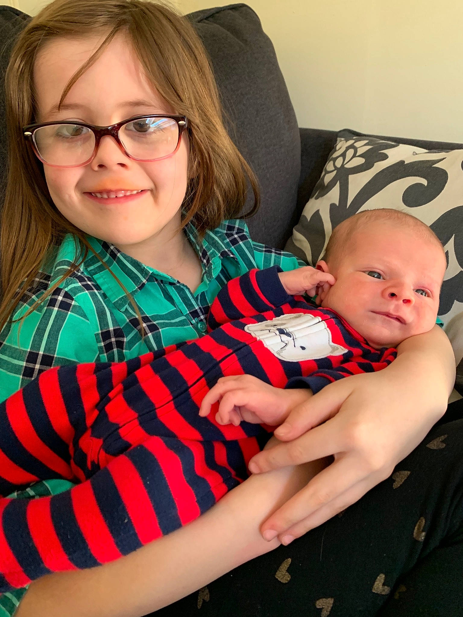 Sophia joined the competition — help win amazing prizes! arm, baby, child, daughter, design, face, family, glasses, head, joy, lap, mother, pattern, people, person, plaid, sitting, skin, smile, toddler