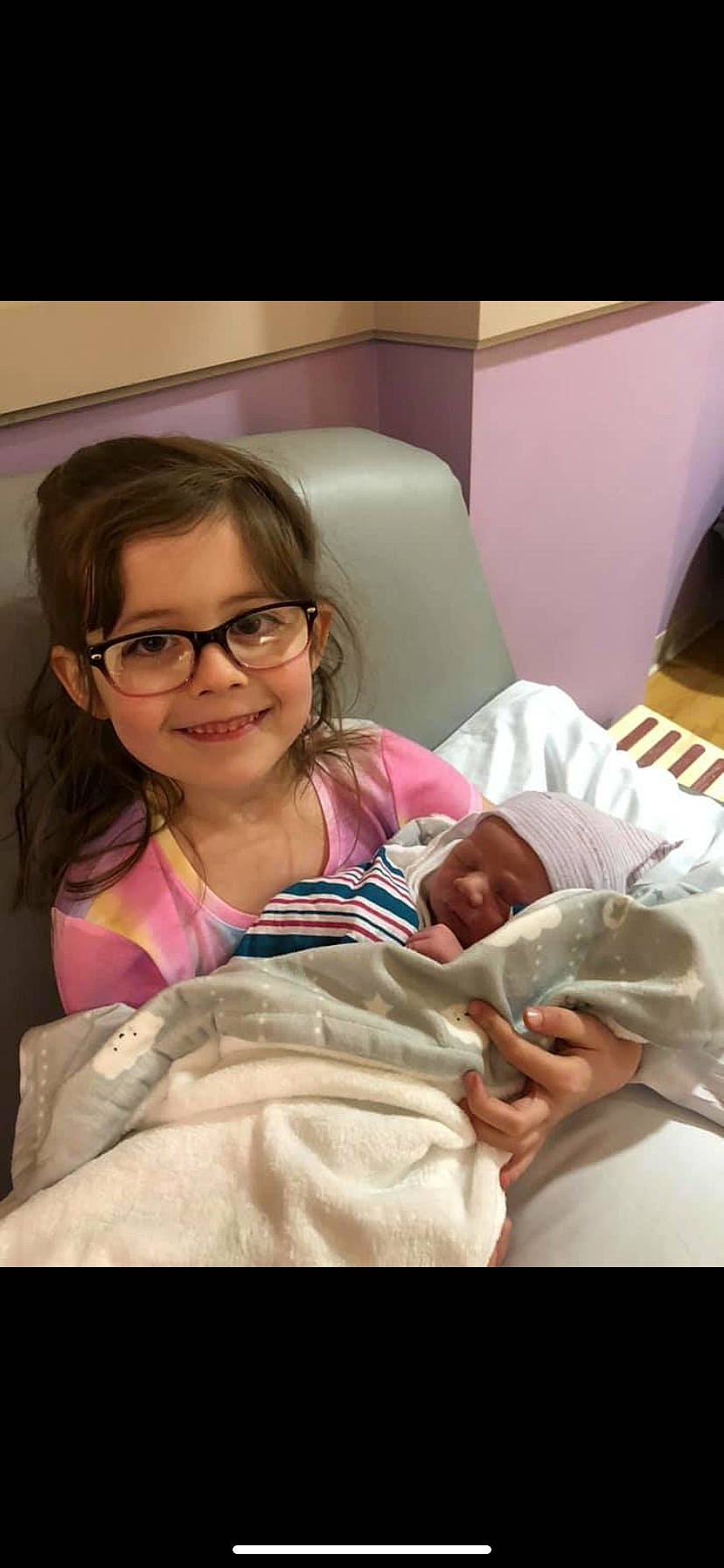 Sophia is registered to the contest to win money with this photo: baby, birth, child, eyewear, glasses, joy, linens, mouth, person, sitting, skin, smile, toddler, tooth, vision_care