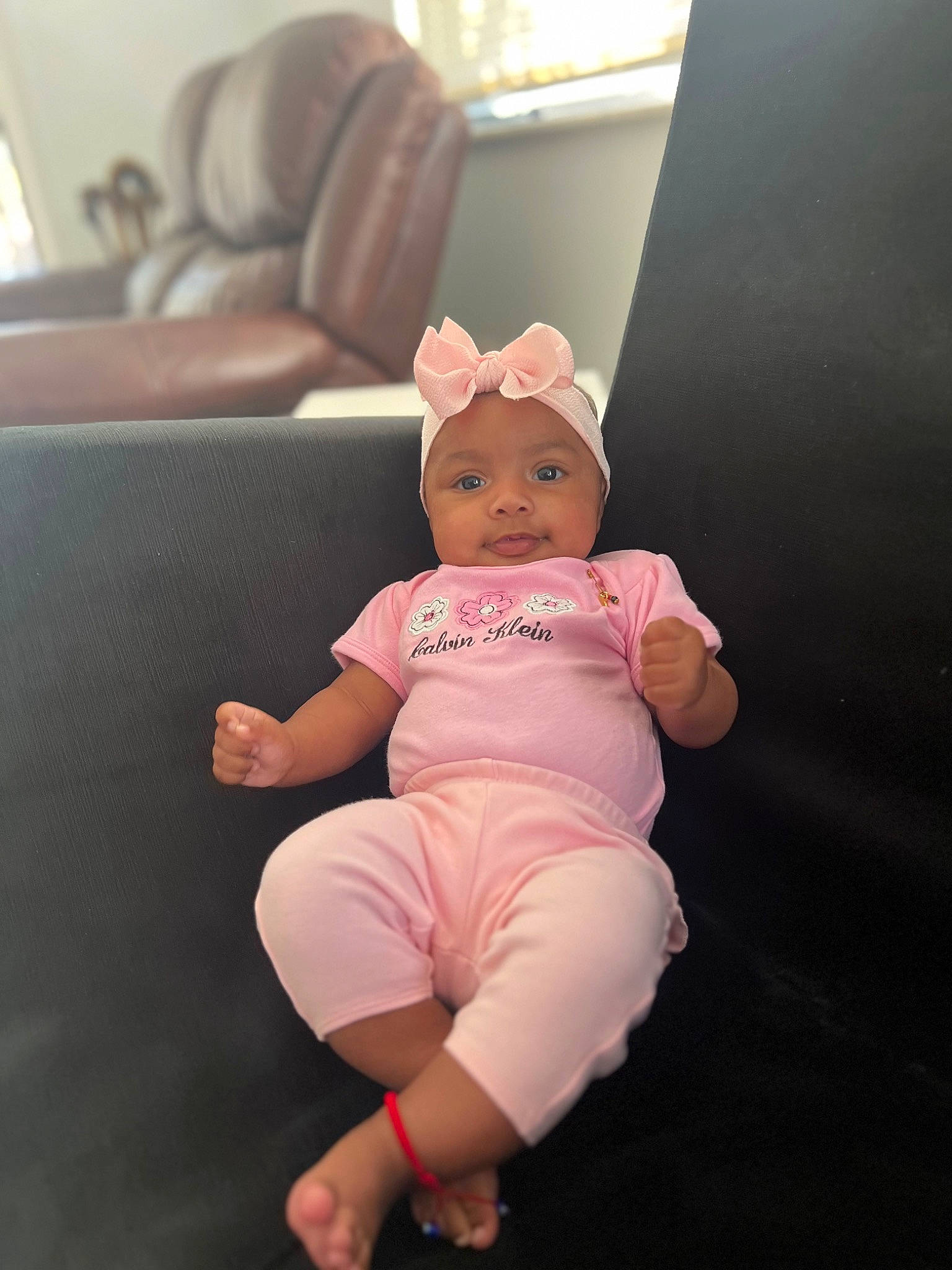 Génesis joined the competition — help win amazing prizes! baby, baby_toddler_clothing, comfort, couch, eye, flooring, foot, fun, happy, hat, headwear, human_body, human_leg, person, pink, sitting, sleeve, sock, t_shirt, thigh