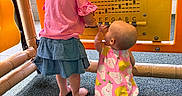 Dailynn joined the competition — help win amazing prizes! toddler, child, playground, musical_panel, yellow_panel, pink_clothing, blue_skirt, romper, barefoot, curly_hair, kneeling, standing, indoor_play_area, flooring, exploring, play, children, infant, interaction, colorful