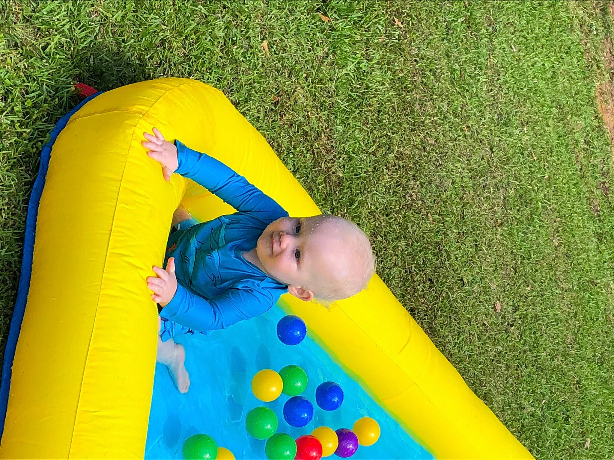 Dallas is registered to the contest to win money with this photo: baby, baby_toddler_clothing, bounce_house, child, chute, fun, games, grass, grassland, green, inflatable, leisure, outdoor_play_equipment, people_in_nature, person, plant, play, playground, recreation, toddler