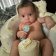 Kairo joined the competition — help win amazing prizes! baby, infant, toy, rattle, seat, cushion, teddy_bear_print, indoor, child, person, skin, expression, serious, hand, face, head, legs, comfort, furniture, curtains