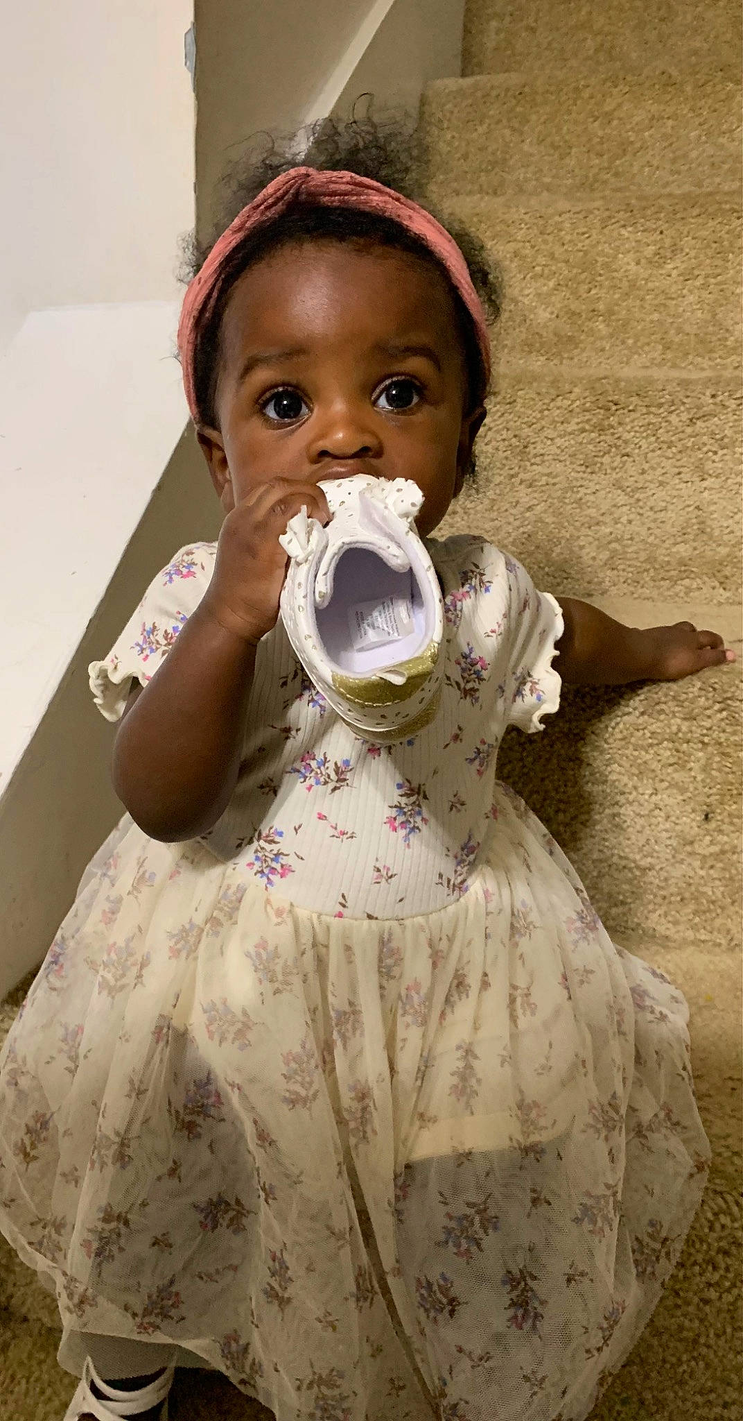 Leia is registered to the contest to win money with this photo: arm, baby_toddler_clothing, cheek, day_dress, dress, eyelash, face, finger, hand, head, headgear, lip, neck, one_piece_garment, organ, person, shoulder, skin, sleeve, textile