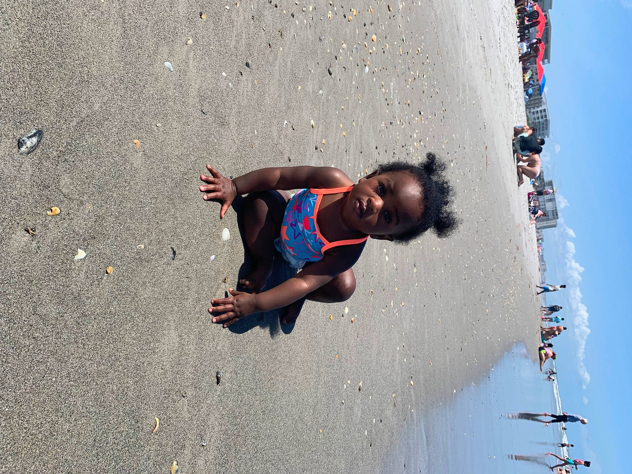Leia is registered to the contest to win money with this photo: asphalt, beach, child, competition_event, concrete, electric_blue, fun, happy, leisure, pedestrian, person, recreation, road, road_surface, sand, shadow, soil, toddler, vacation, water