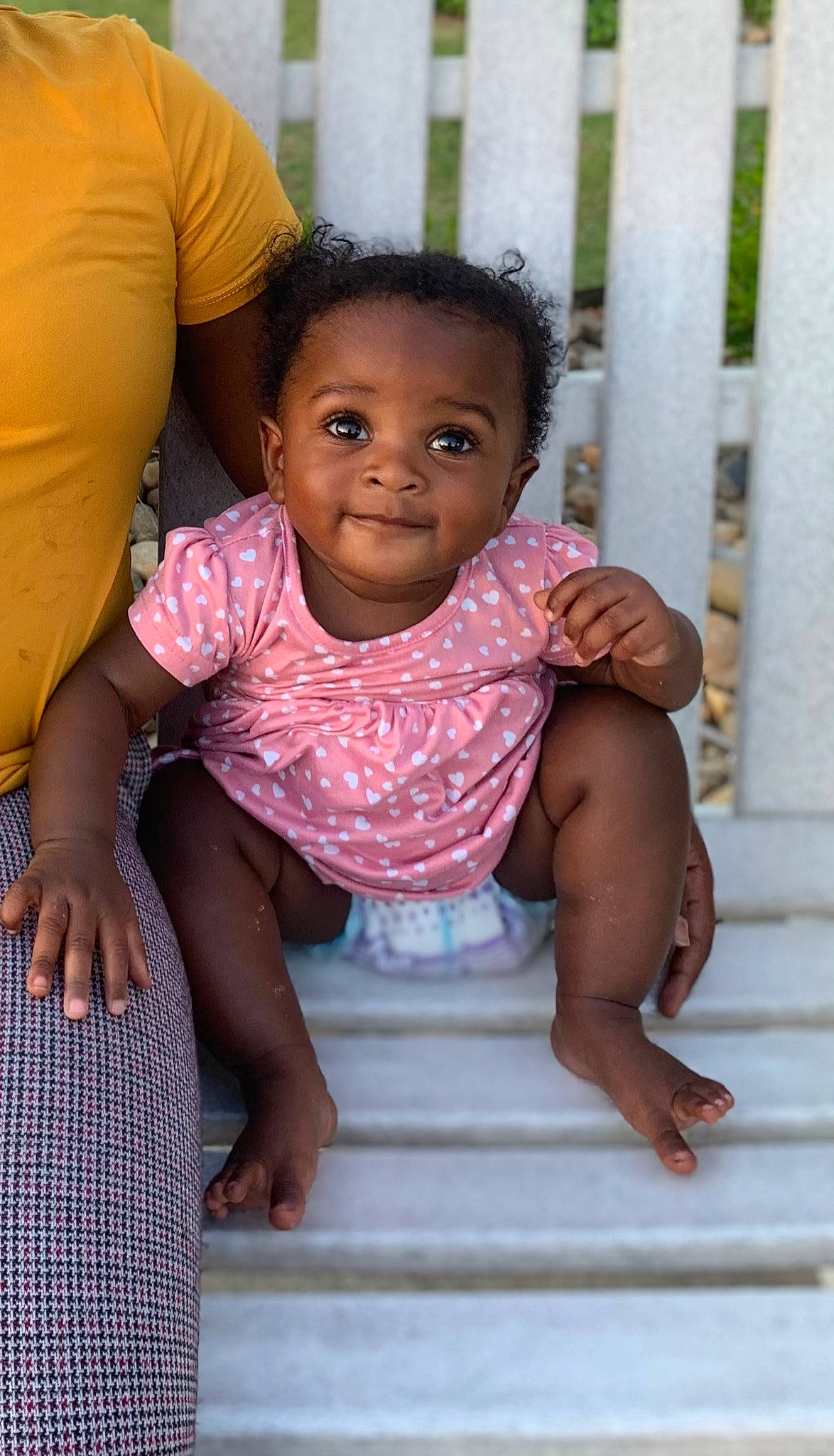 Leia is registered to the contest to win money with this photo: arm, baby_toddler_clothing, black, cheek, chin, dress, eye, face, hand, happy, human_body, iris, joy, leg, lip, mouth, nose, person, skin, sleeve