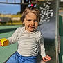 toddler, child, playground, slide, toy, yellow, jeans, white_shirt, hair_tie, topknot, smiling, outdoor, sunny, daytime, playing, happy, casual_clothing, young_child, park, fun