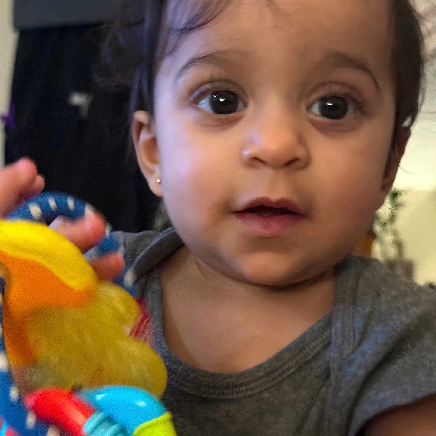 Kathalina is registered to the contest to win money with this photo: baby, child, closeup, colorful, curly_hair, cute, earring, expression, eyes, face, focus, hand, indoor, person, portrait, shirt, skin, toddler, toy, young_child