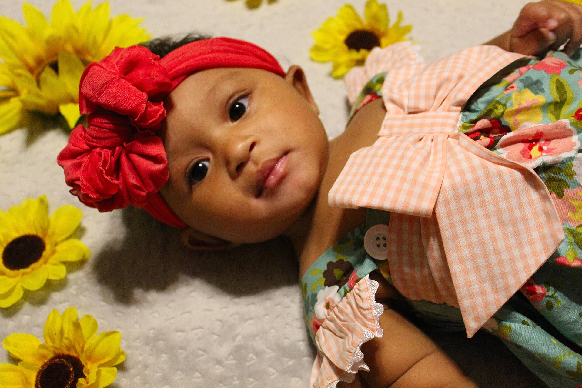 Raeleigh joined the competition — help win amazing prizes! art, cap, child, close_up, doll, fawn, flower, grass, happy, headwear, orange, person, petal, plant, plush, room, stuffed_toy, textile, toy, wood