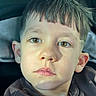 child, boy, portrait, face, brown_eyes, haircut, short_hair, expression, close_up, skin, casual_clothing, indoor, seat, young, person, head, looking, childhood, cute, thoughtful