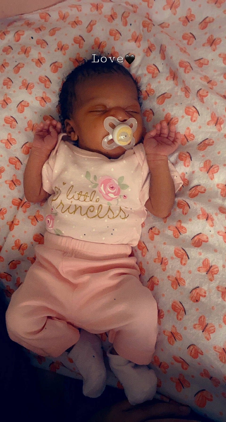 Kianna is registered to the contest to win money with this photo: arm, baby, baby_products, baby_toddler_clothing, cheek, child, comfort, eye, face, fun, happy, linens, nose, orange, pattern, person, pink, sitting, skin, sleeve