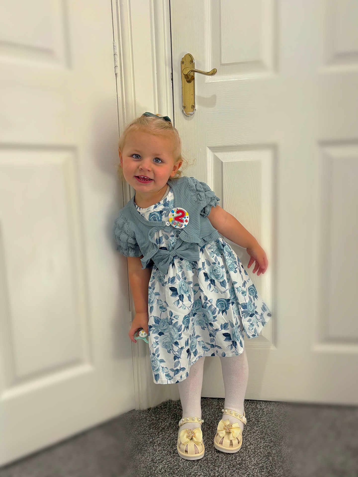 Delilah-mae joined the competition — help win amazing prizes! birthday, birthday_badge, blue, bow, cardigan, carpet, child, cute, door, dress, floor, girl, happy, indoor, person, shoes, smile, standing, tights, two_years_old