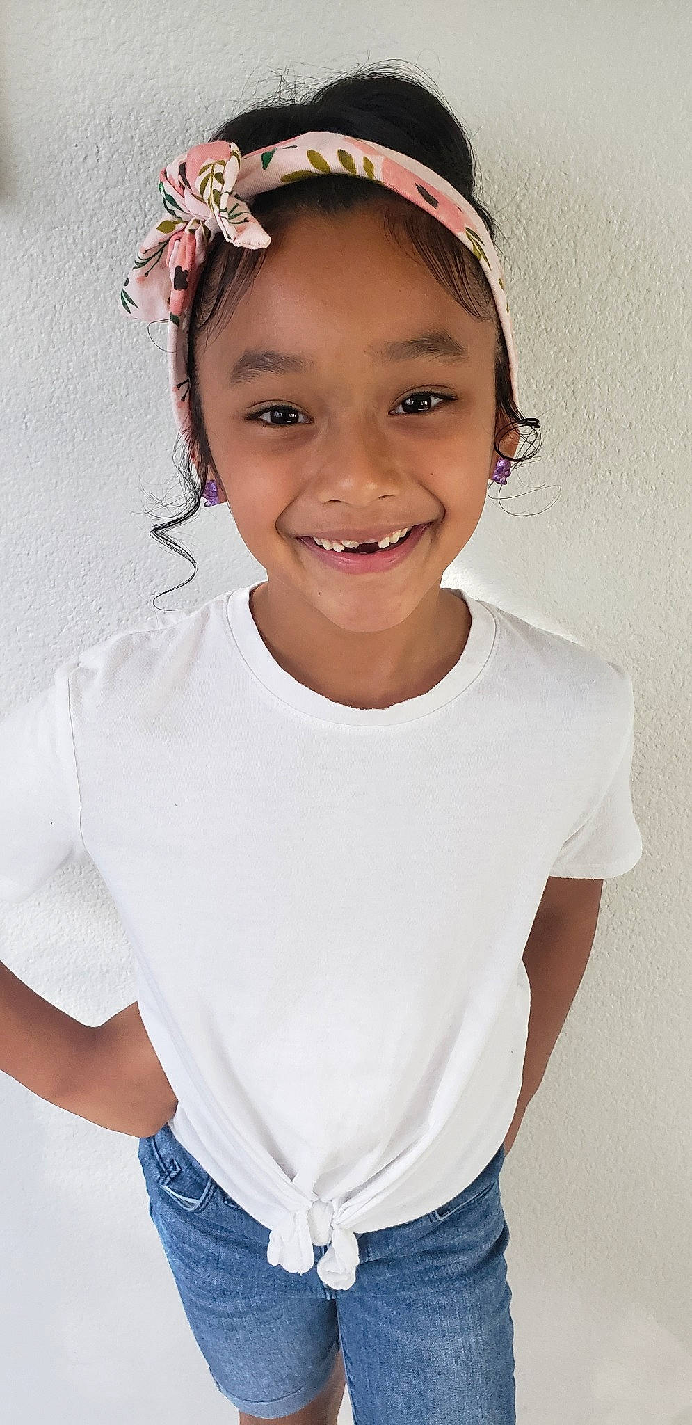 Kaleah is registered to the contest to win money with this photo: child, child_model, chin, clothing, fashion_accessory, gesture, hair, hair_accessory, hairstyle, headband, headgear, headpiece, joy, lip, neck, person, shoulder, sleeve, smile, t_shirt