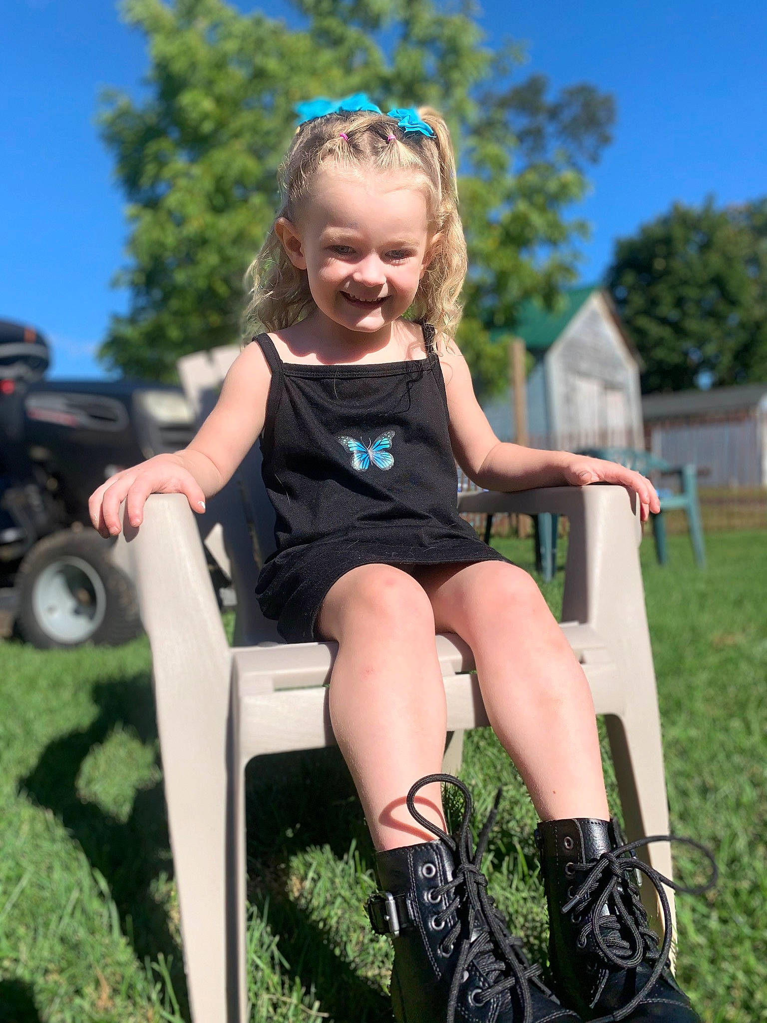 Kenzie is registered to the contest to win money with this photo: dress, electric_blue, eye, fun, grass, hair, happy, joy, knee, leg, leisure, people_in_nature, person, recreation, shorts, sky, smile, thigh, tire, toddler