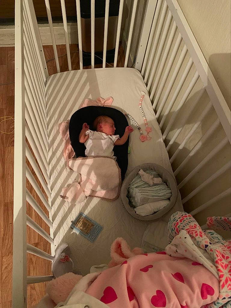 Myriam Batsheva participe au concours pour gagner de l'argent avec cette photo : baby, baby_products, baby_safety, bed, bed_sheet, bedtime, child, furniture, infant_bed, linens, person, pink, product, room, textile, under_exposed