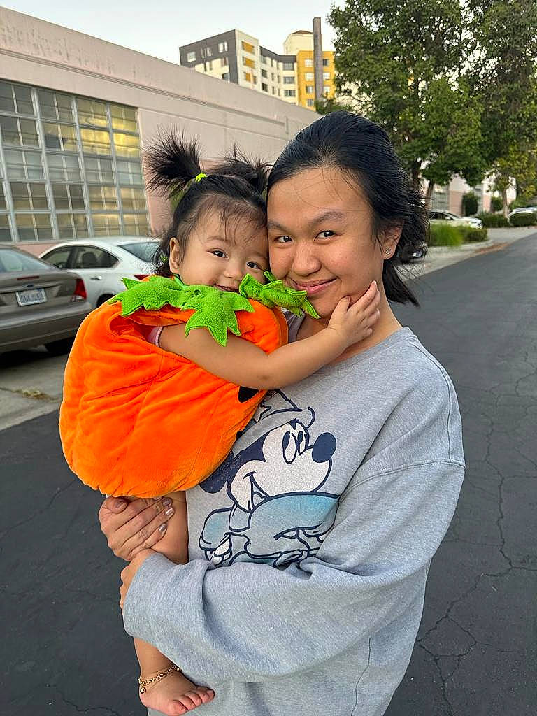 Clarissa is registered to the contest to win money with this photo: asphalt, car, event, facial_expression, finger, friendship, fun, gesture, grass, hairstyle, happy, joy, leisure, mouth, orange, person, plant, recreation, smile, travel