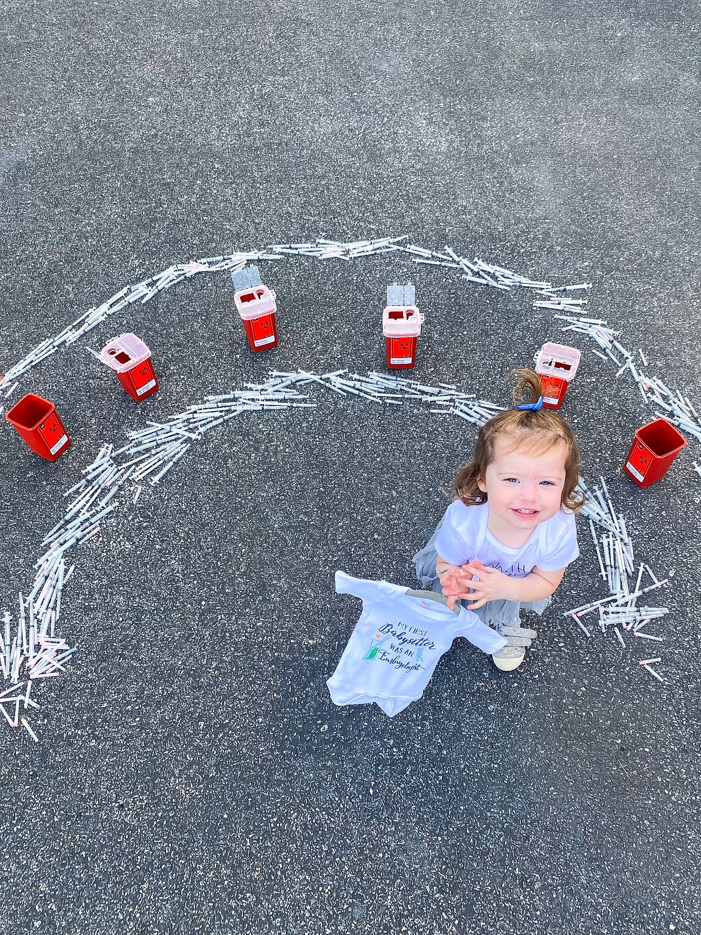Brooklynn is registered to the contest to win money with this photo: asphalt, automotive_tire, baby, baby_toddler_clothing, carmine, circle, concrete, flooring, font, fun, grass, joy, person, recreation, road, road_surface, sand, shadow, sidewalk, soil