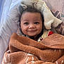 baby, smile, blanket, cozy, child, infant, face, hood, pattern, soft, seat, cute, happy, warm, wrapped, indoor, portrait, young, comfort, closeup