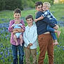 Louis joined the competition — help win amazing prizes! children, boys, baby_doll, field, bluebonnets, grass, nature, outdoor, smiling, barefoot, casual_clothing, family, greenery, sunlight, portrait, child, happy, holding, young, playing