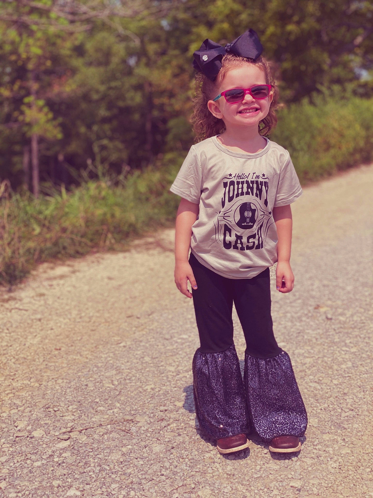 Jojo is registered to the contest to win money with this photo: asphalt, child, cool, eyewear, footwear, fun, glasses, happy, joy, nose, person, pink, recreation, shoe, smile, standing, summer, sunglasses, t_shirt, toddler